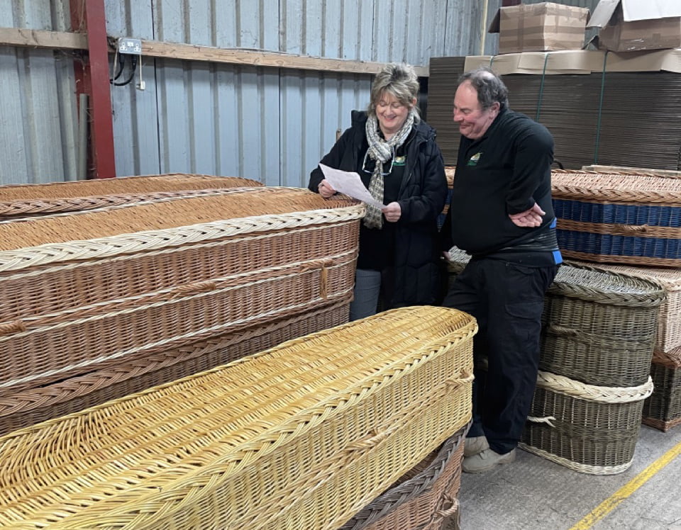 Jane talking to Jeff with a willow coffin in front of them